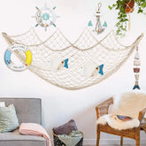 AquaHaven Decor nautical fishing net wall decor with seashells and driftwood, perfect for coastal home and Airbnb interior decoration.