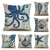AquaHaven Decor ocean-themed throw pillow cover with coastal blue waves and seashell design for home or Airbnb decor.