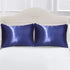 Set of two AquaHaven Decor soft satin pillowcases with smooth, shiny fabric, perfect for adding elegance to bedroom decor.