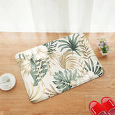 AquaHaven Decor palm leaf plush bath mat with non-slip backing and memory foam, soft textured surface for bathroom comfort.