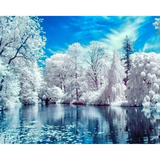 Winter snow scene diamond painting by AquaHaven Decor showing a festive winter landscape with snow-covered trees and a cozy cabin.